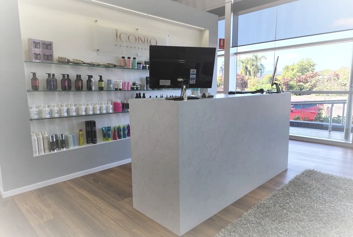 Iconiq Salon front desk in Cairns with product shelving and windows